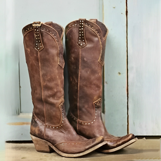 Brown cowboy boots with embossed details and a rustic finish